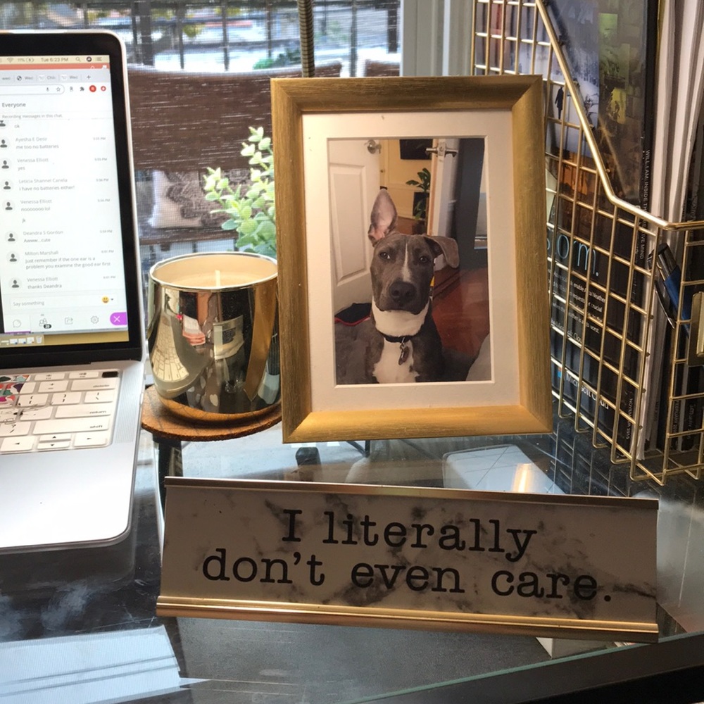 Desk sign reads “I literally don’t even care”